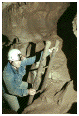 photo of a caver climbing a ladder