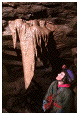 photo of caver admiring a drapery formation